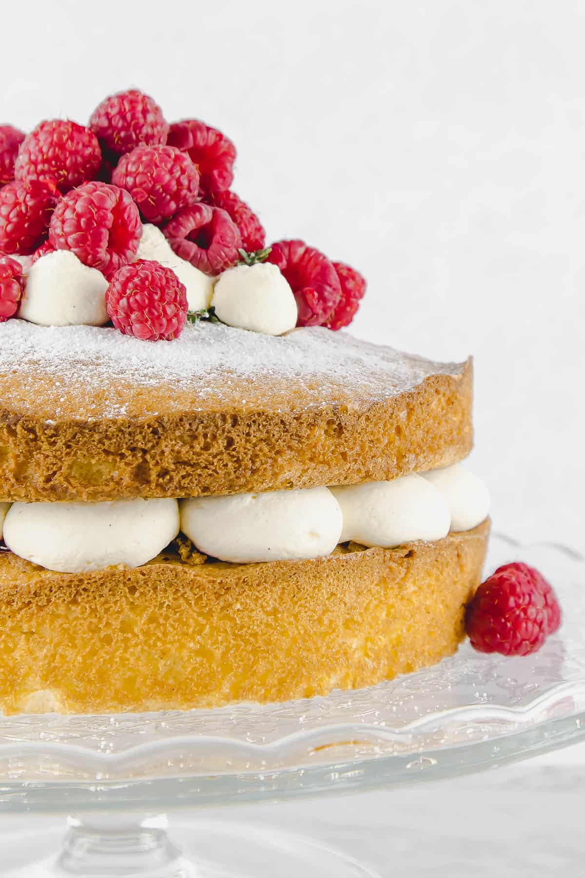 Close up of raspberry Victoria sponge with fresh cream between the cake layers