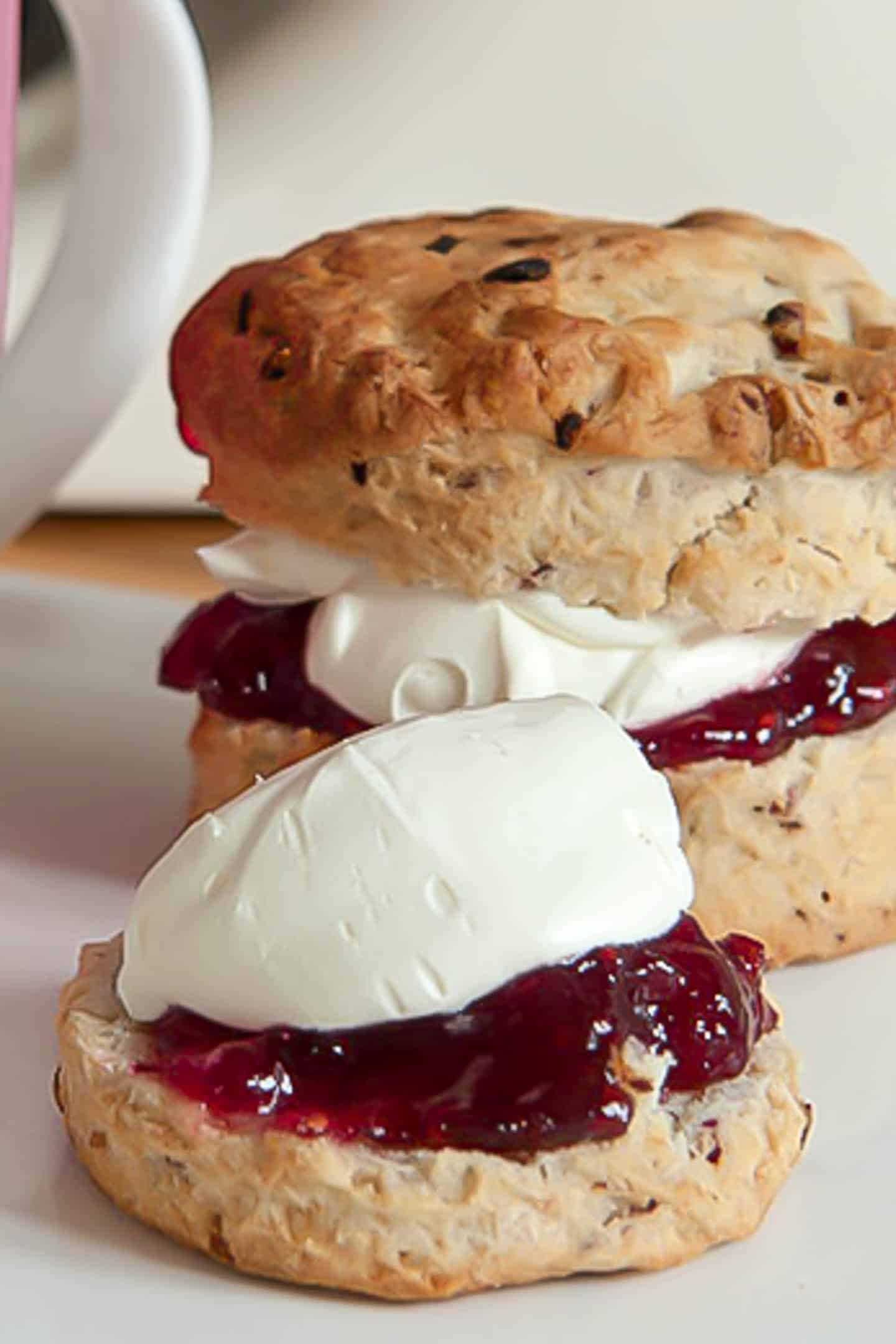 Raspberry and white chocolate scones topped with jam and cream