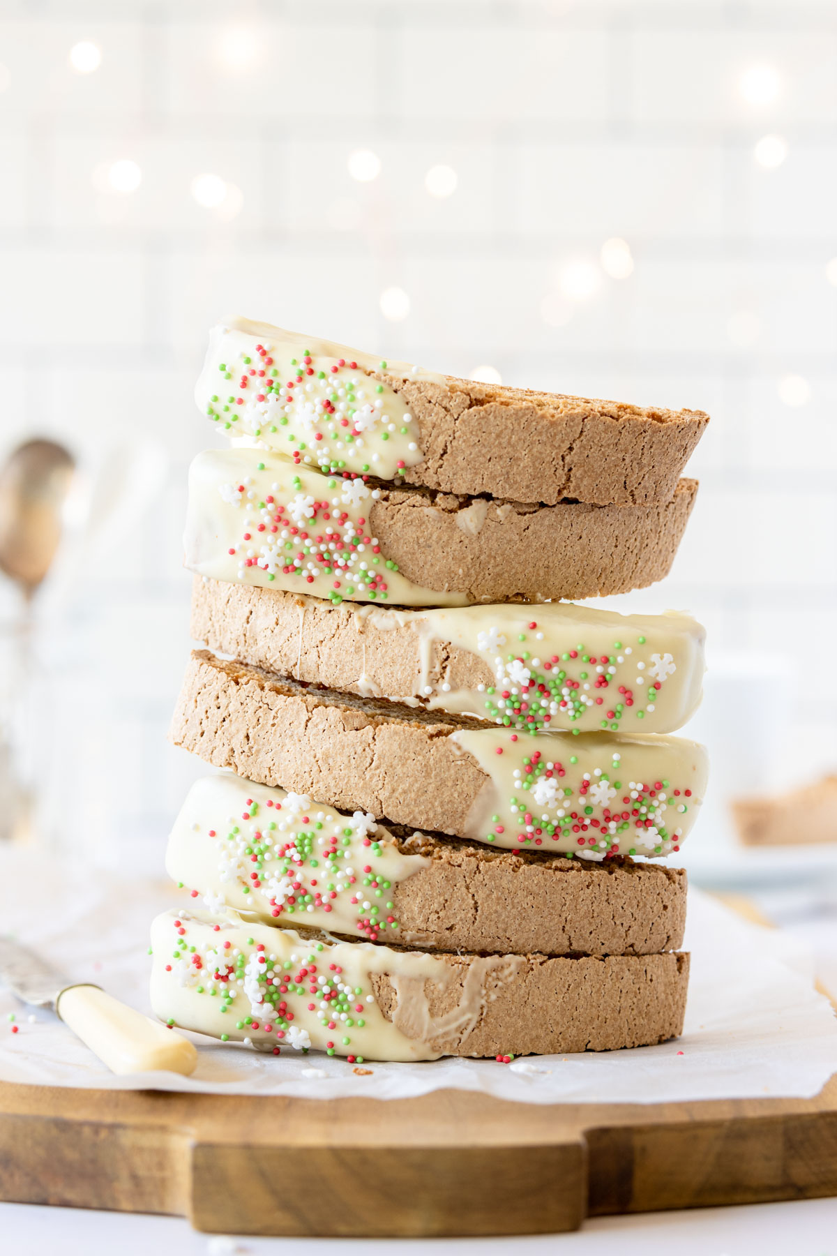 Stack of white chocolate gingerbread biscotti with red and green sprinkles.