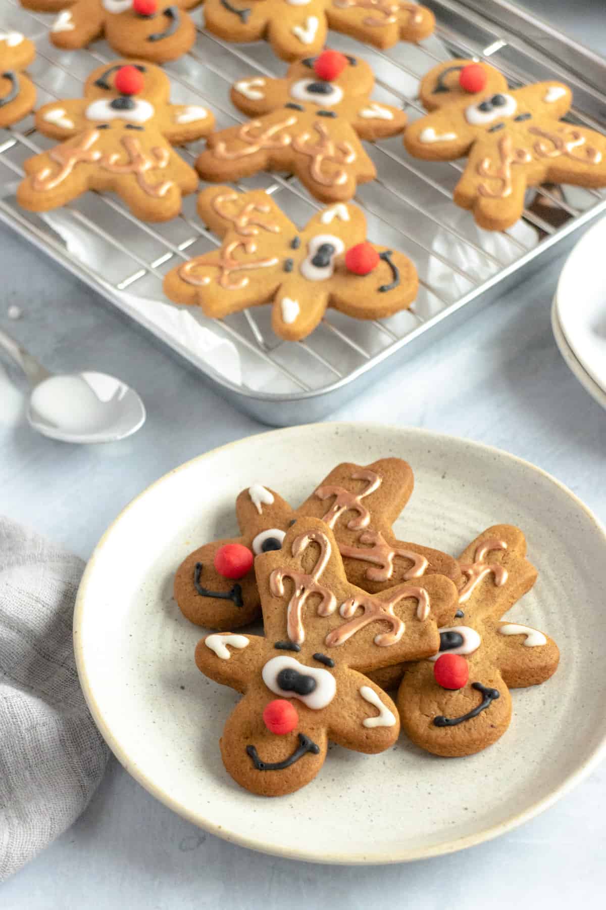 Gingerbread men decorated like reindeer on a plate