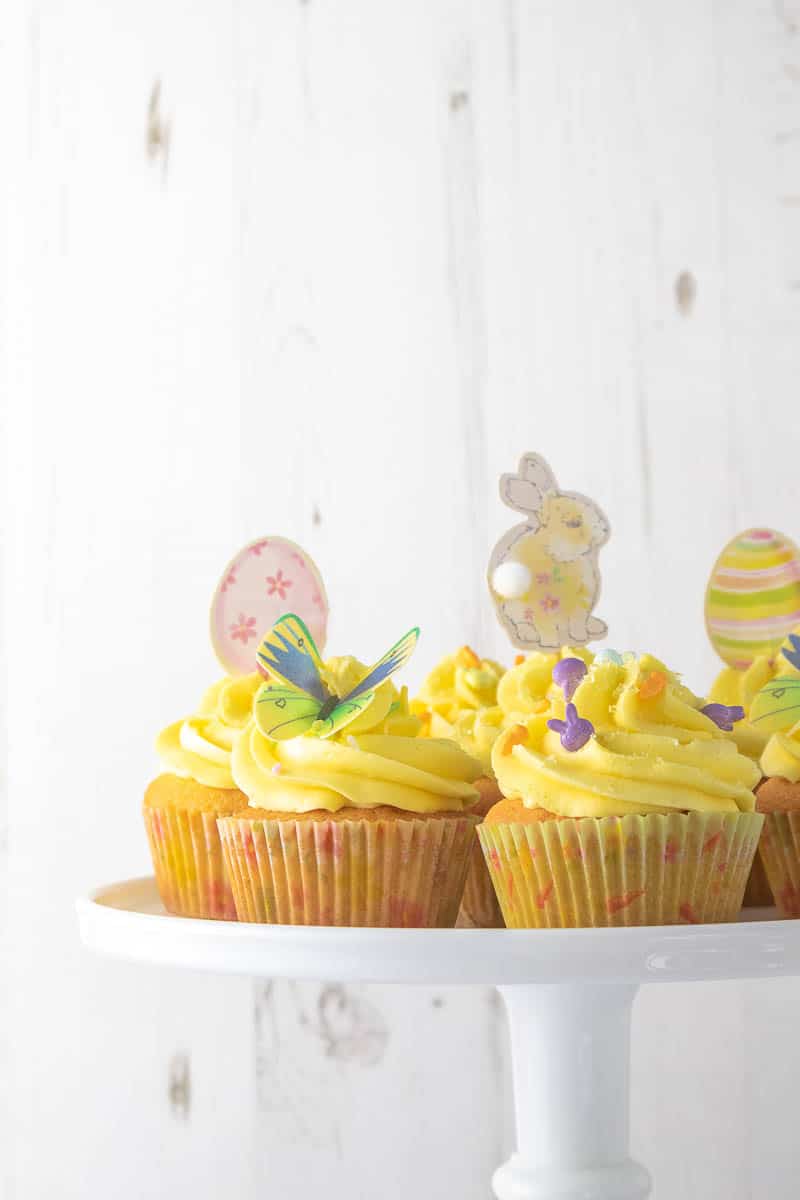 These vanilla cupcakes are light and fluffy, and utterly delicious. Topped with creamy whipped vanilla buttercream, and with a hidden chocolate surprise inside, these are easy to put together and make the perfect Easter cupcake alternative to chocolate eggs.
