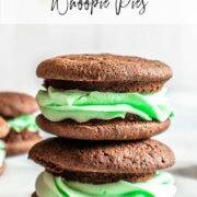 Two chocolate whoopie pies, filled with green mint frosting, stacked on top on each other