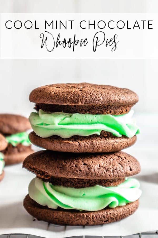 Two chocolate whoopie pies, filled with green mint frosting, stacked on top on each other