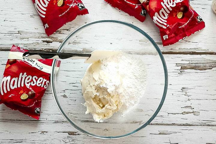 Icing sugar and cream cheese in a large mixing bowl