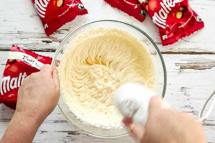 Mixing the cheesecake filling with a hand whisk