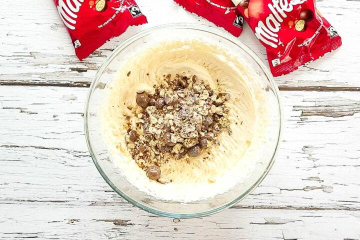 Crushed Maltesers in a bowl with cheesecake filling