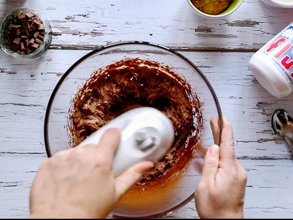 Mixing a chocolate cream with a hand mixer
