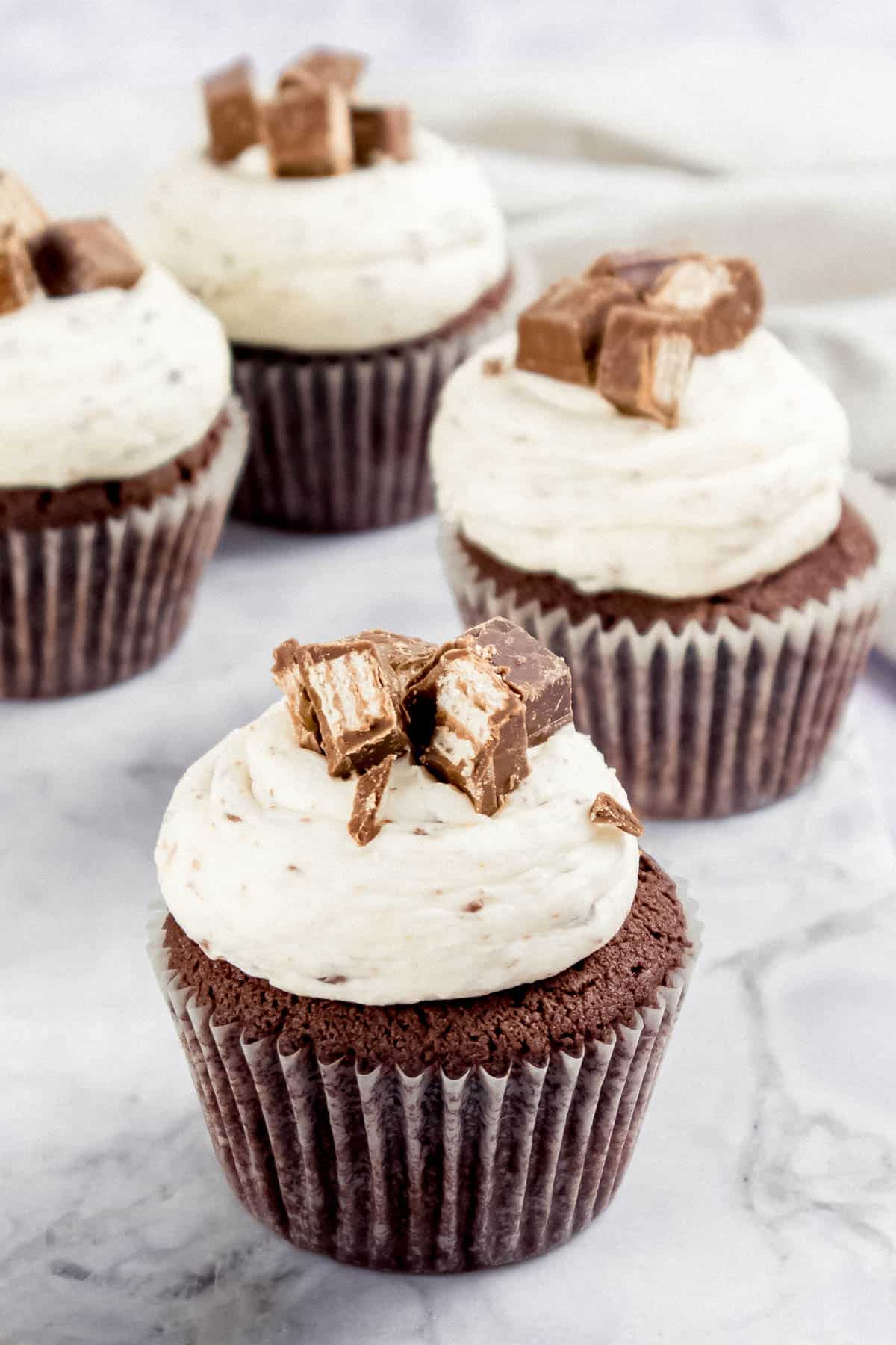 Chocolate cupcakes topped with vanilla buttercrean and Kit Kat pieces