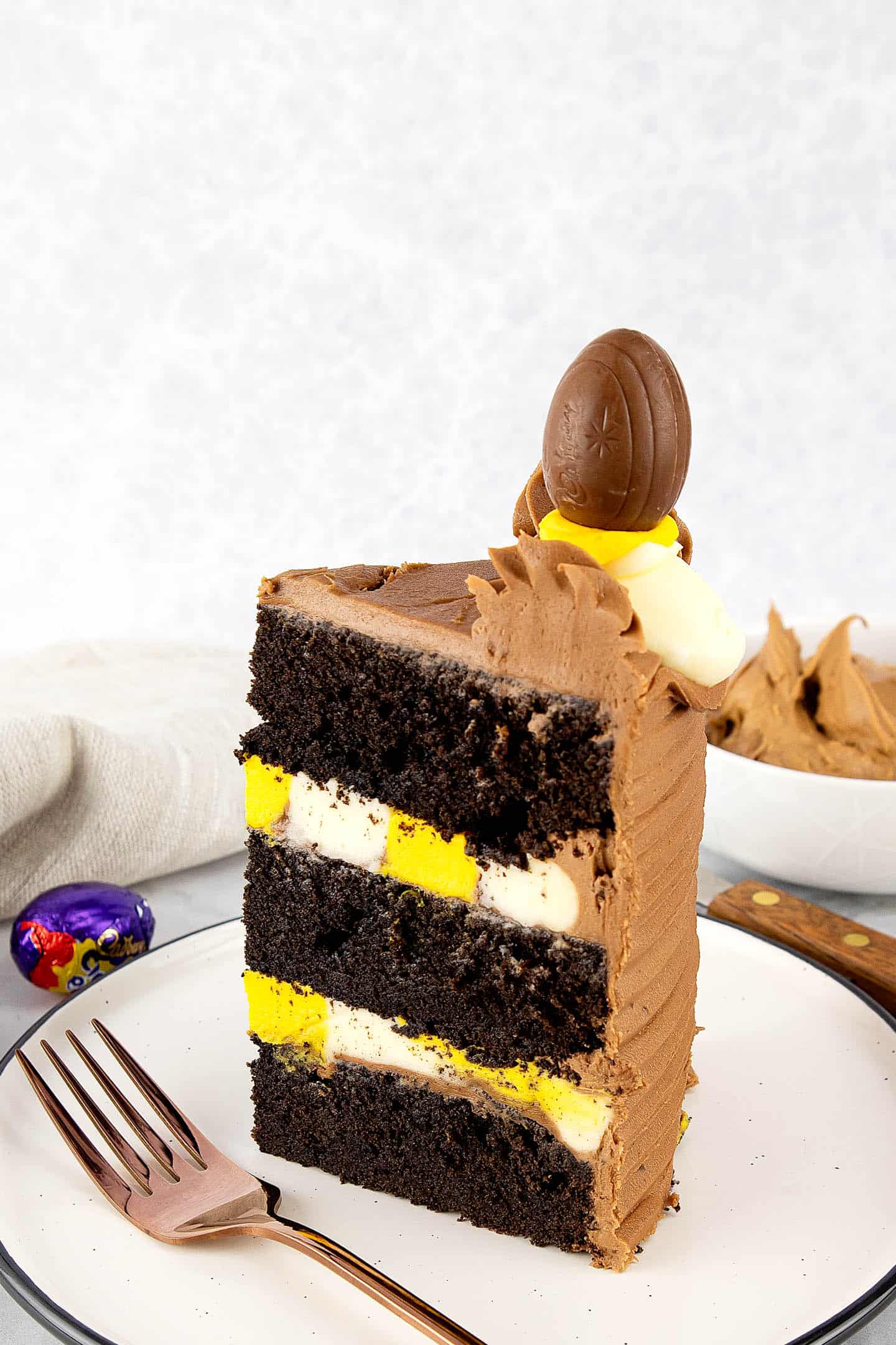 Slice of Creme Egg cake filled with yellow and white vanilla buttercream