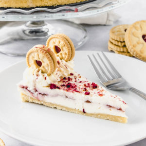 Slice of Jammie Dodger cheesecake on a white plate