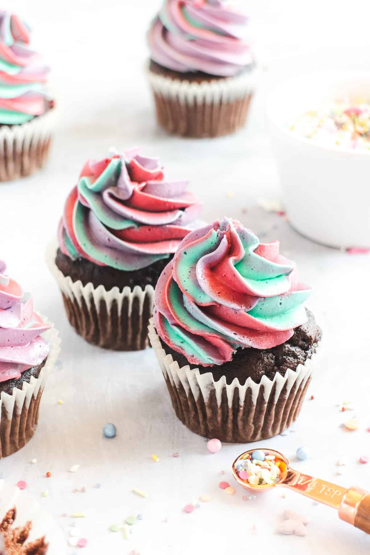 Chocolate cupcakes decorated with multi-coloured frosting