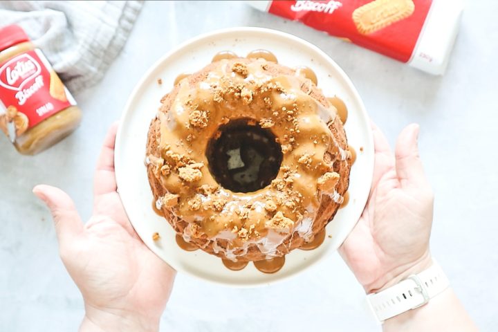 Biscoff Bundt cake on a white cake stand