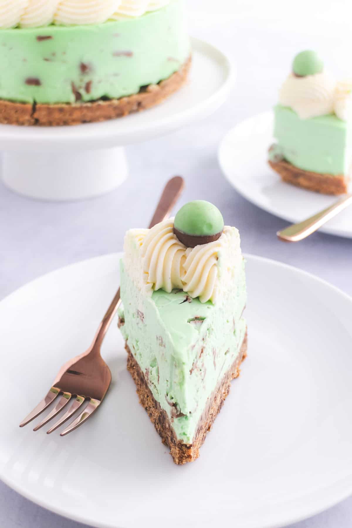 Mint green cheesecake with chunks of chocolate in the filling