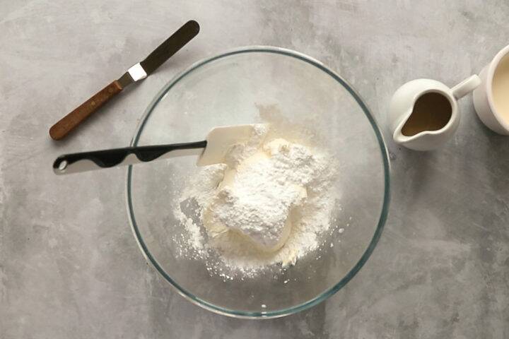 Cream cheese and icing sugar in a bowl