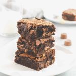 Slices of Rolo brownies stacked on top of each other