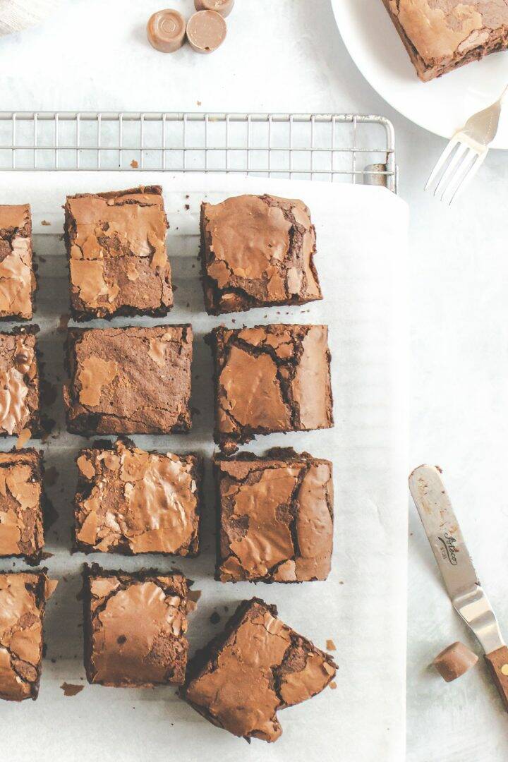 Chocolate tray bake cut into squares on a wire cooling rack
