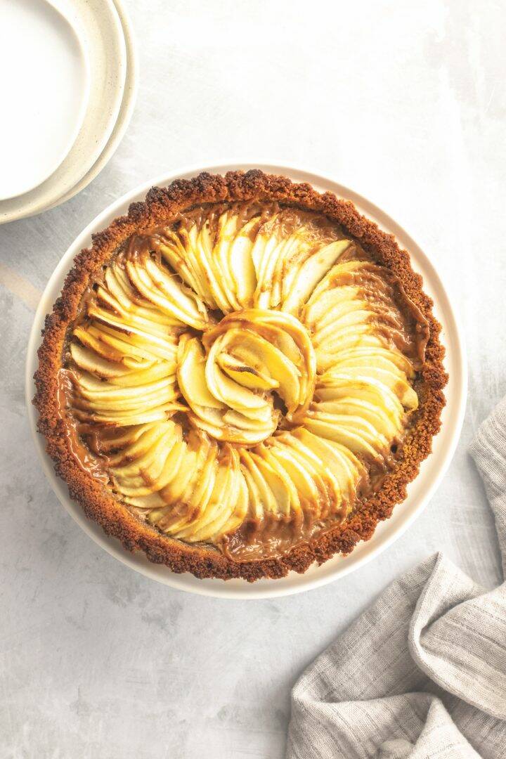 Overhead view of an apple tart filled with apple slices in a spiral