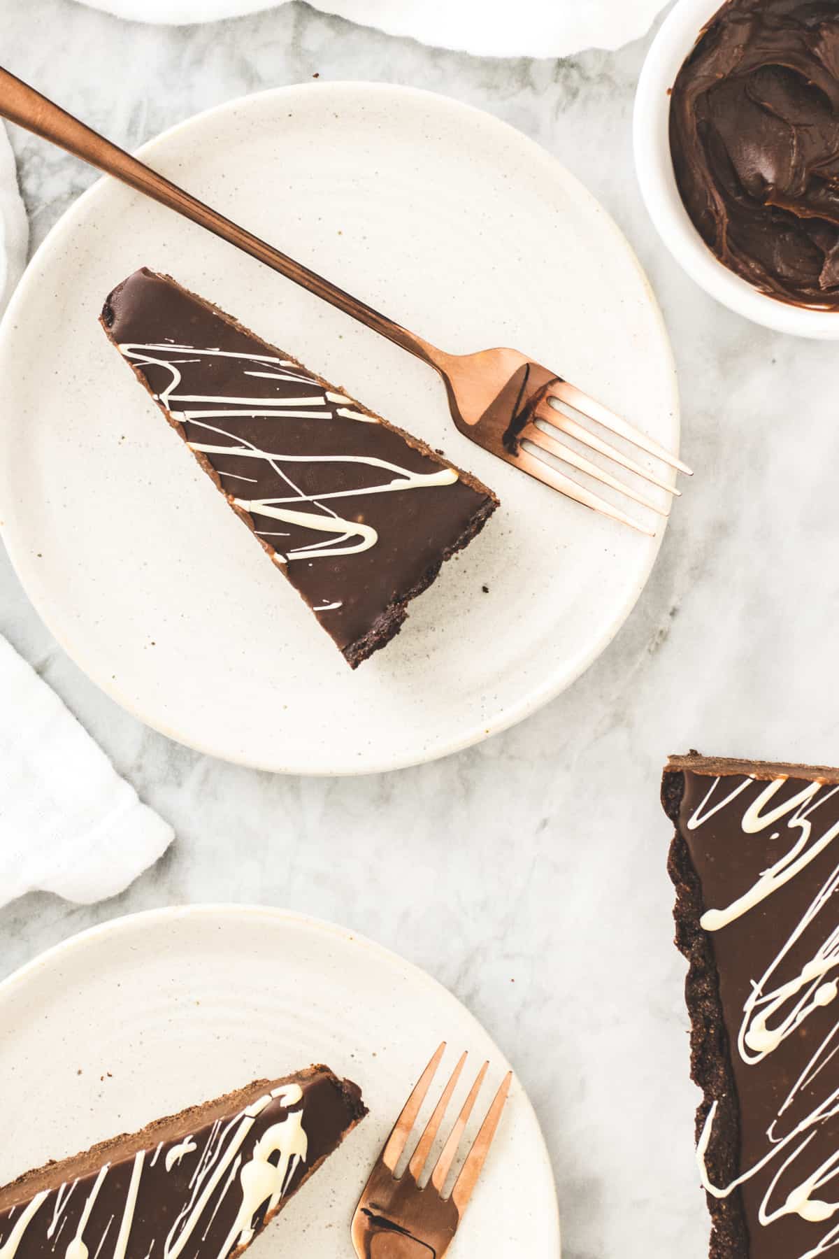 Triangle slices of Baileys tart on white plates