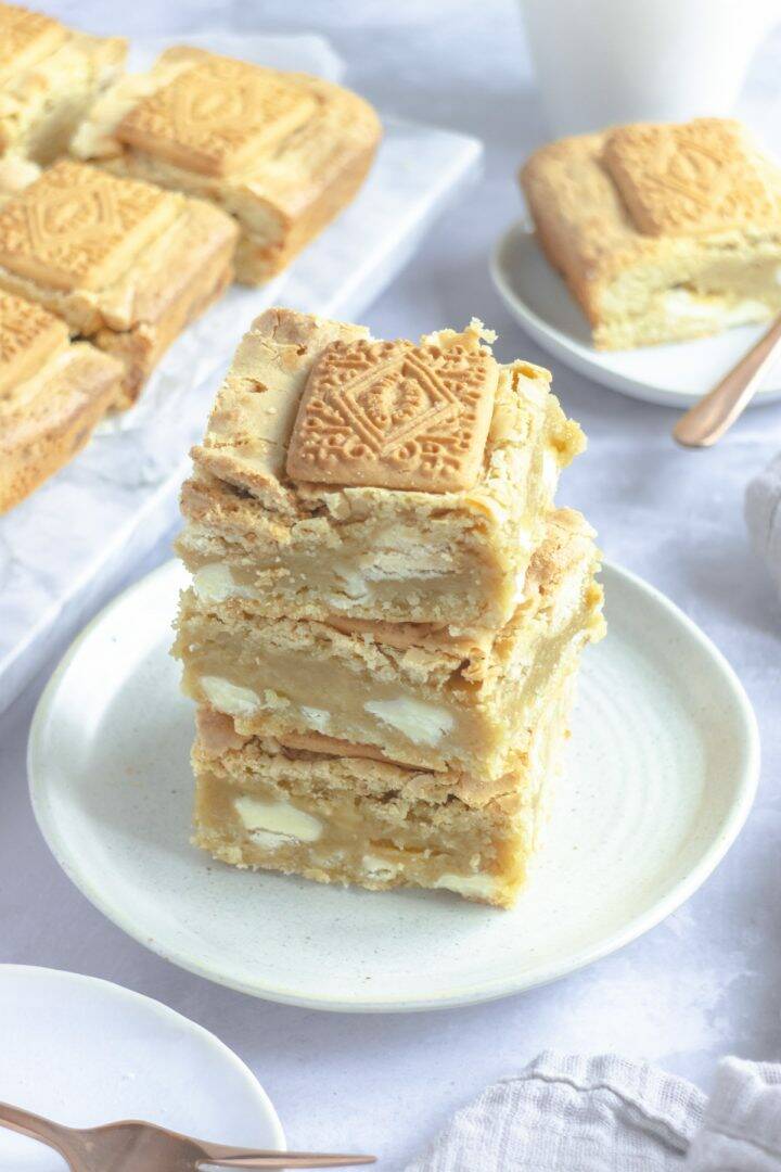 Stack of blondies with biscuit pieces and white chocolate chunks