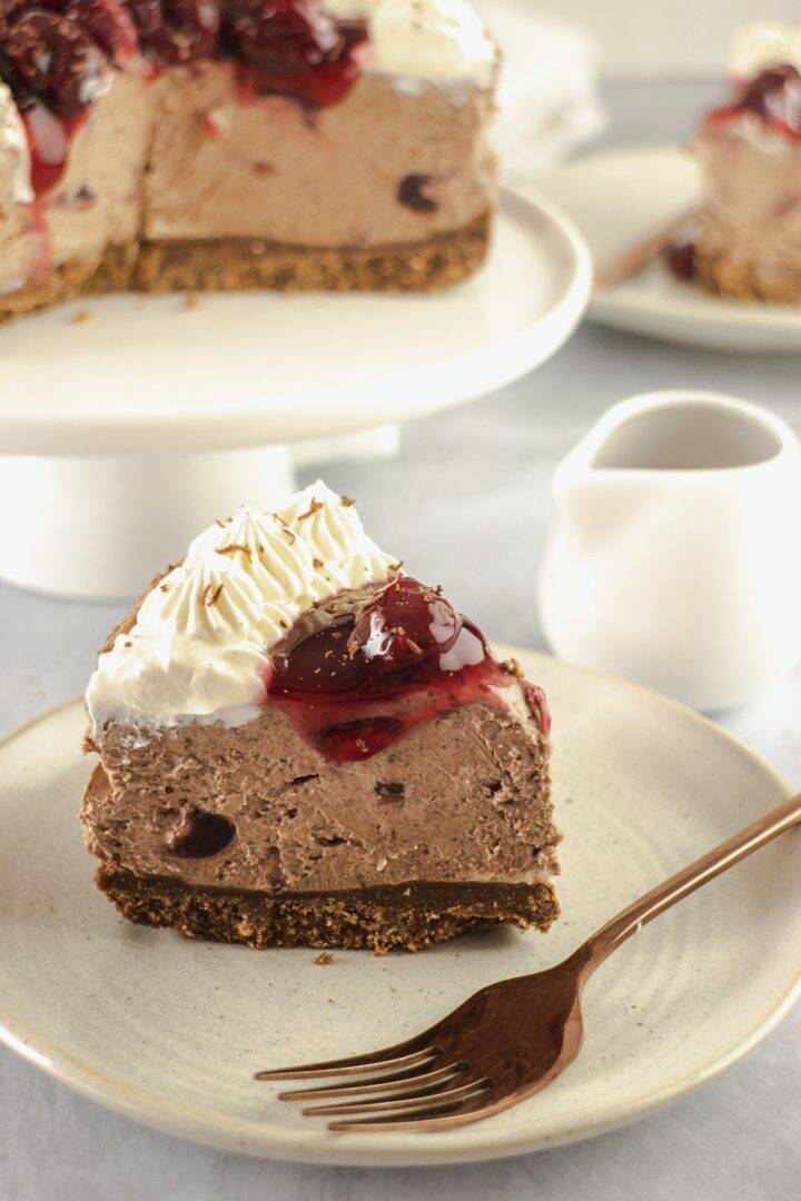 Slice of chocolate cheesecake with cherries on the top