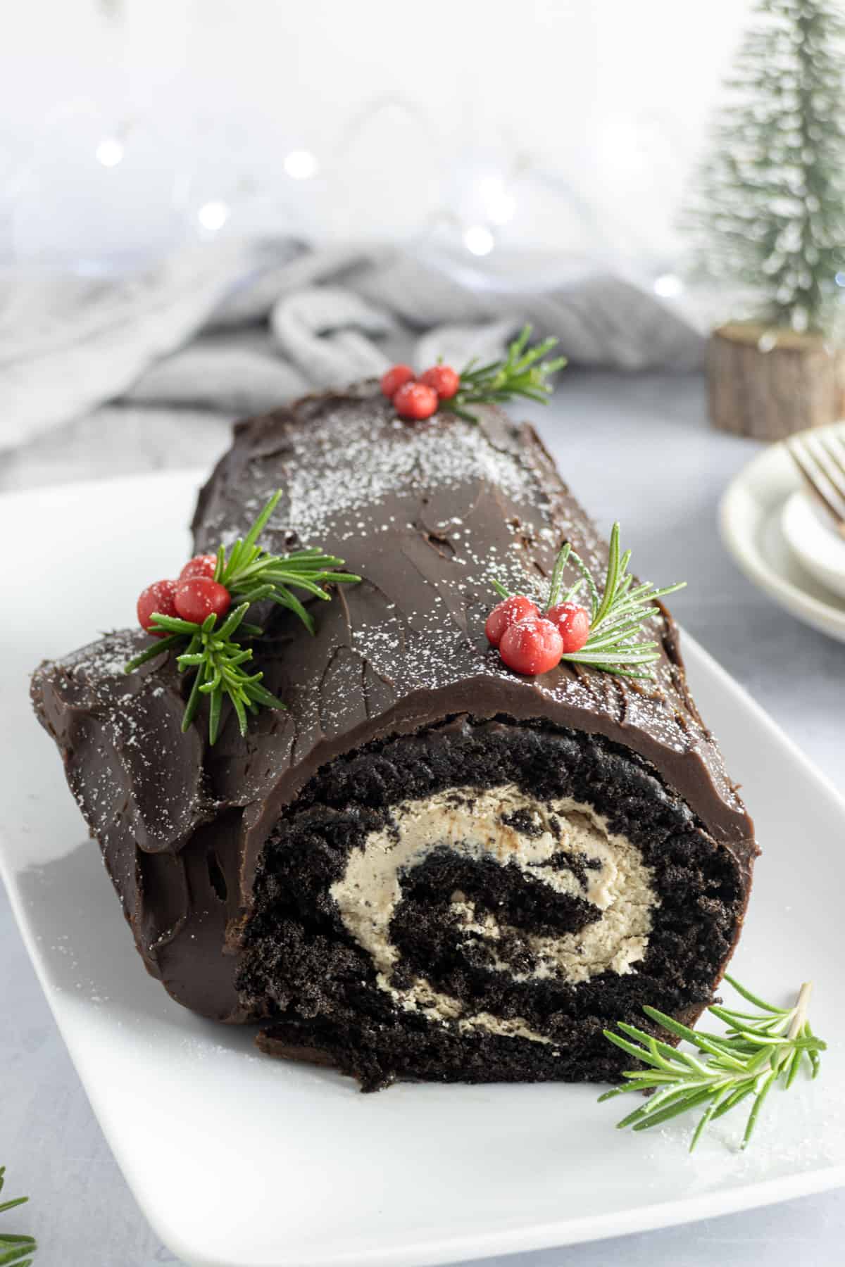 Chocolate roulade decorated with chocolate icing and icing sugar