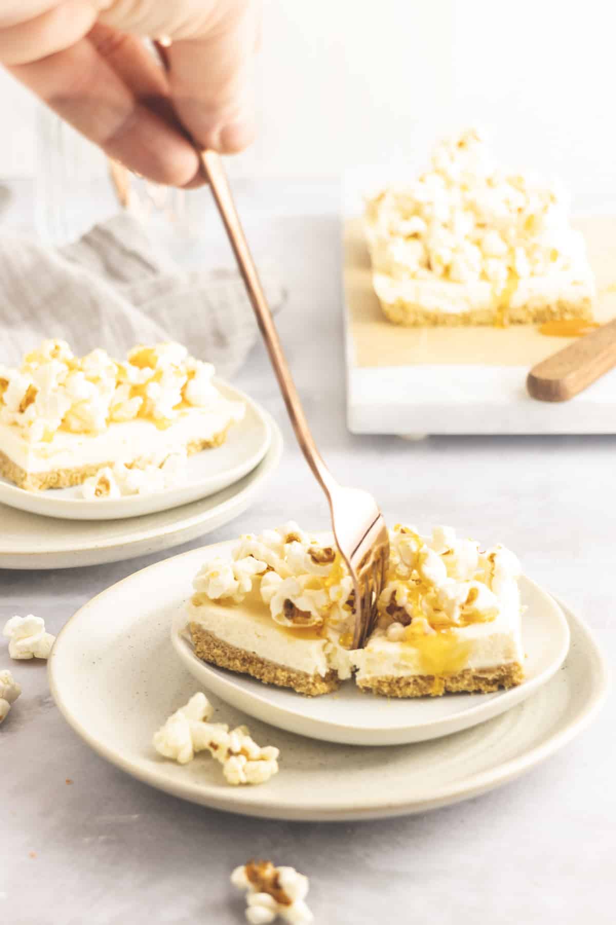 Popcorn bar drizzled with toffee sauce and a fork being placed in it