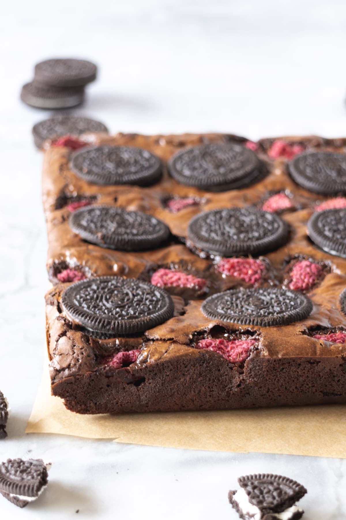 Slab of brownies with summer fruit and oreos on top