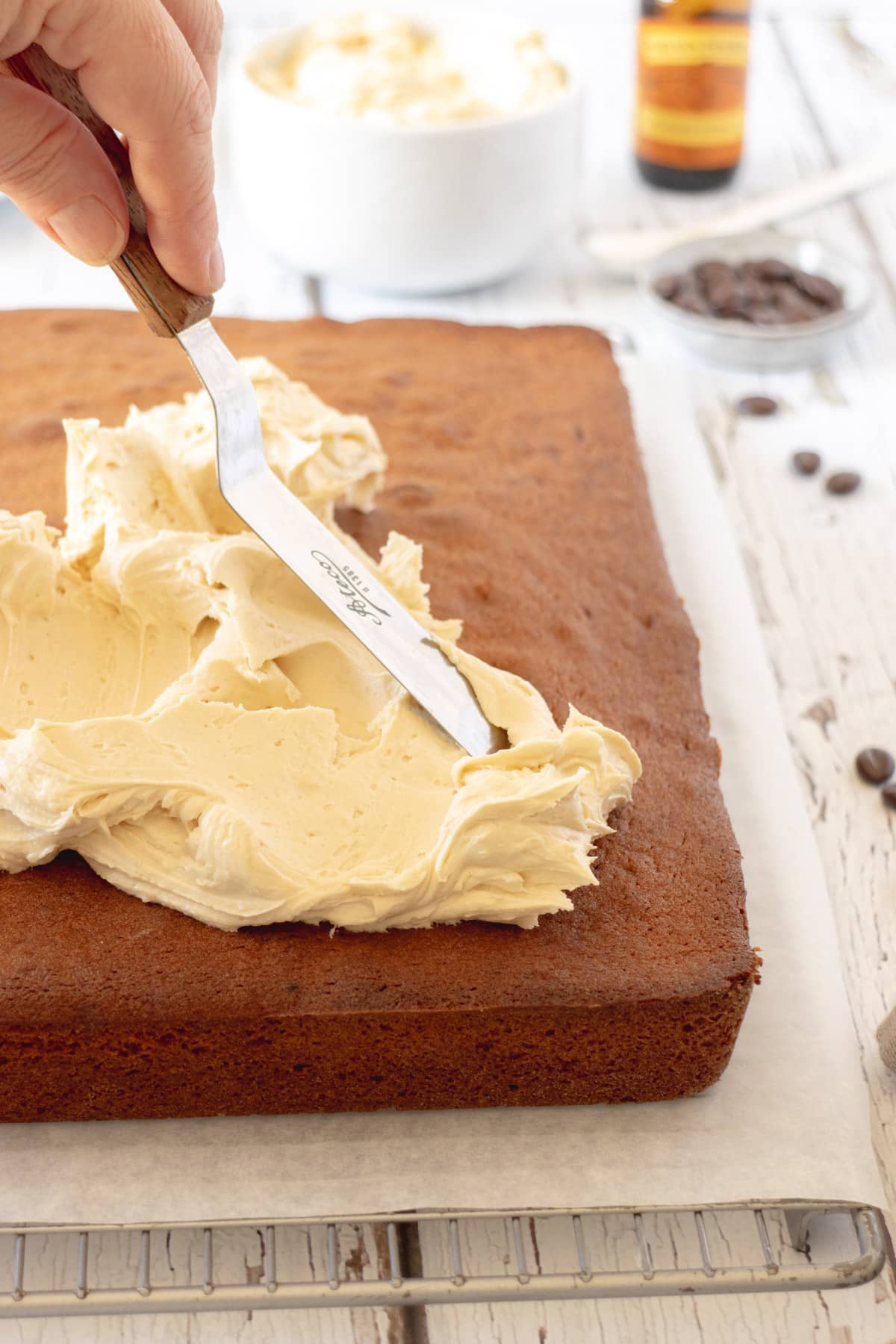 Frosting a coffee sheet cake with an angled spatula