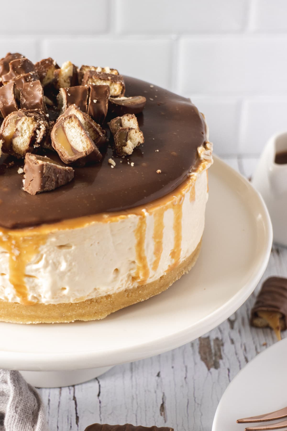 Twix cheesecake with caramel drips down the side