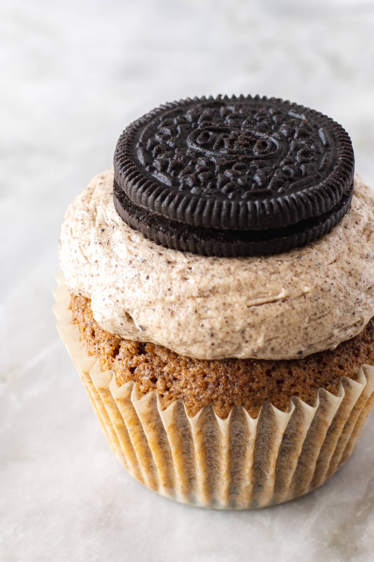Frosted cupcake with an Oreo cookie on top