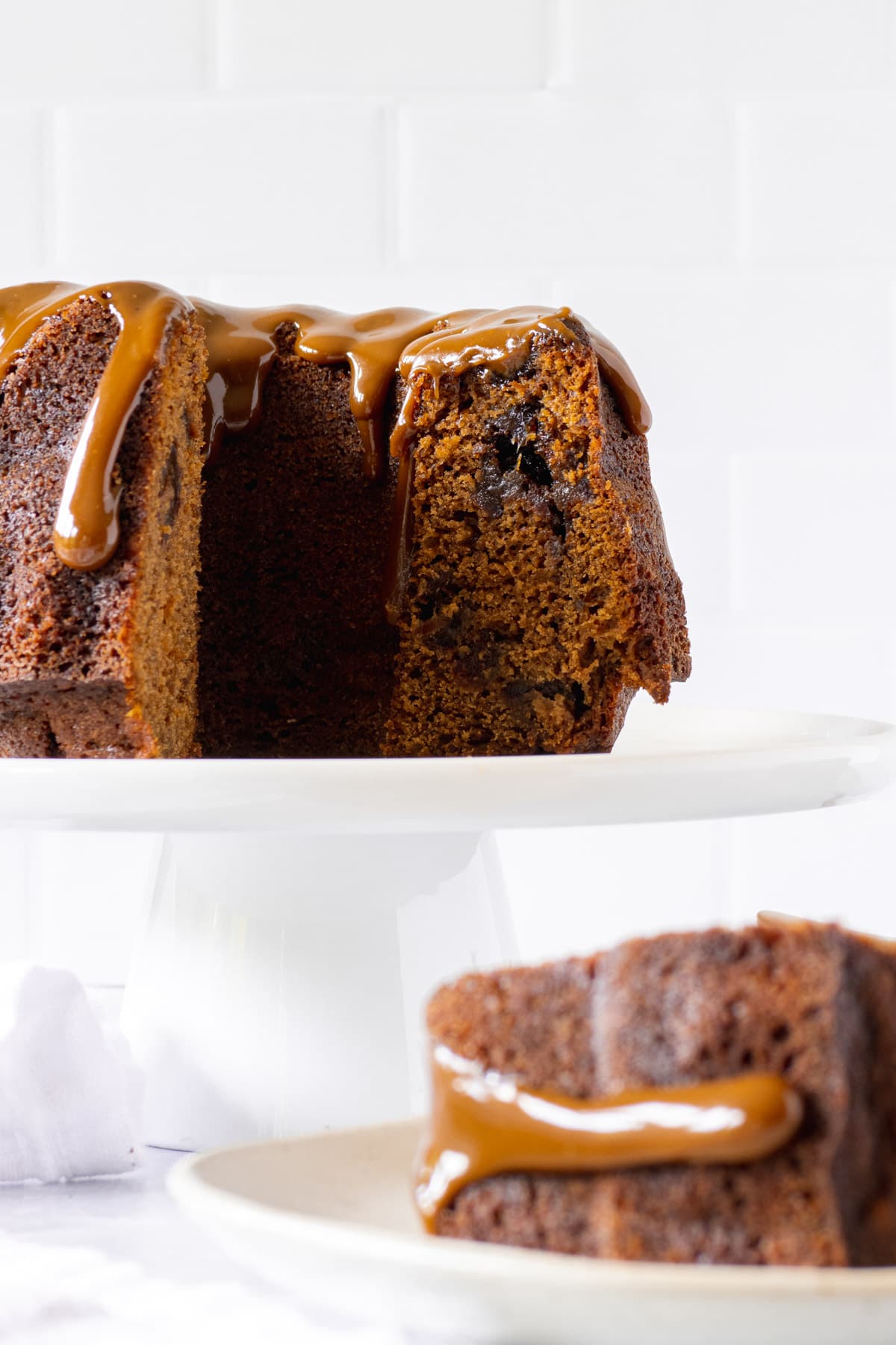 Slice of toffee cake with a toffee sauce drip