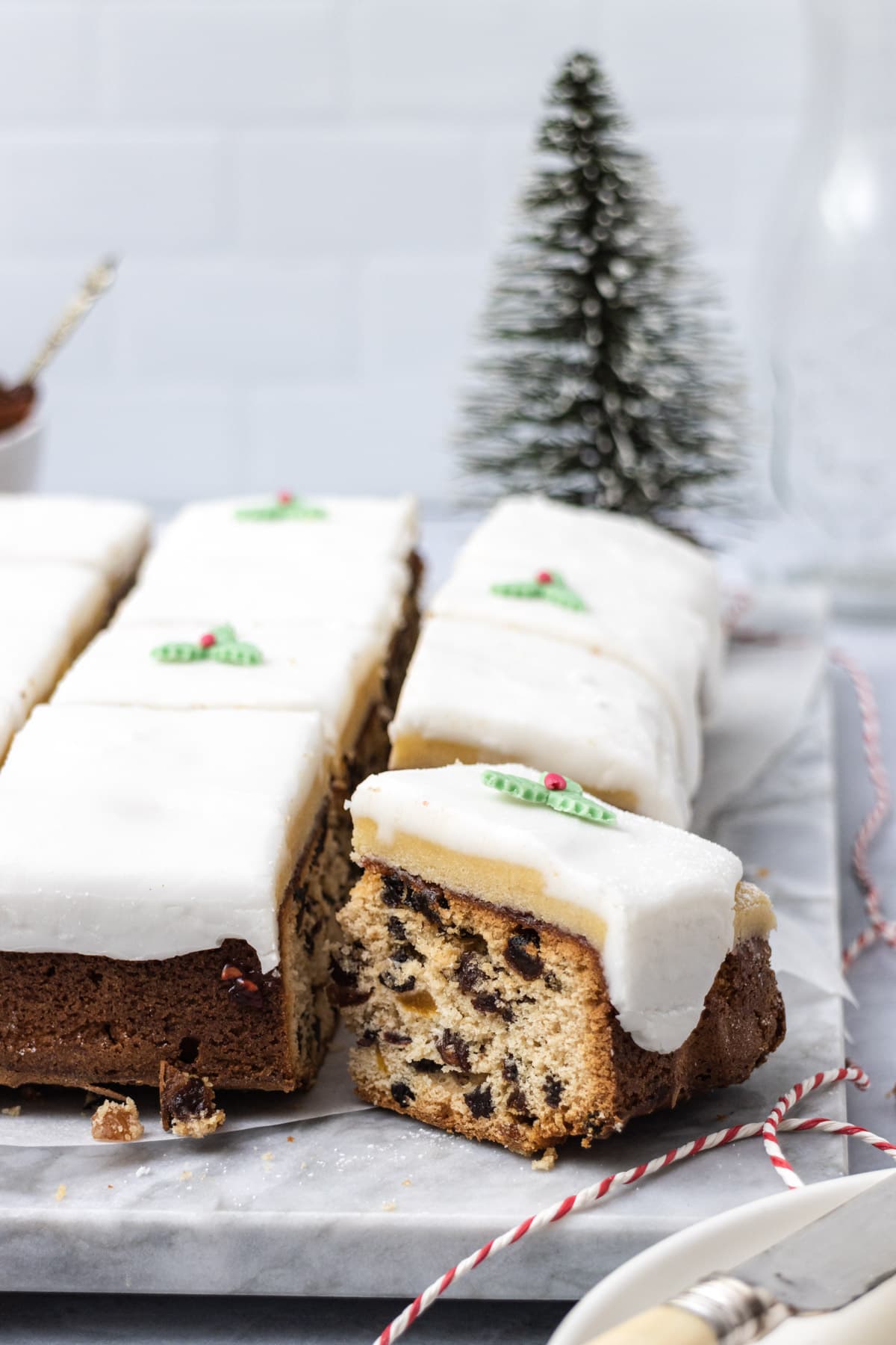 A square of light fruit cake iced with marizpan and white icing
