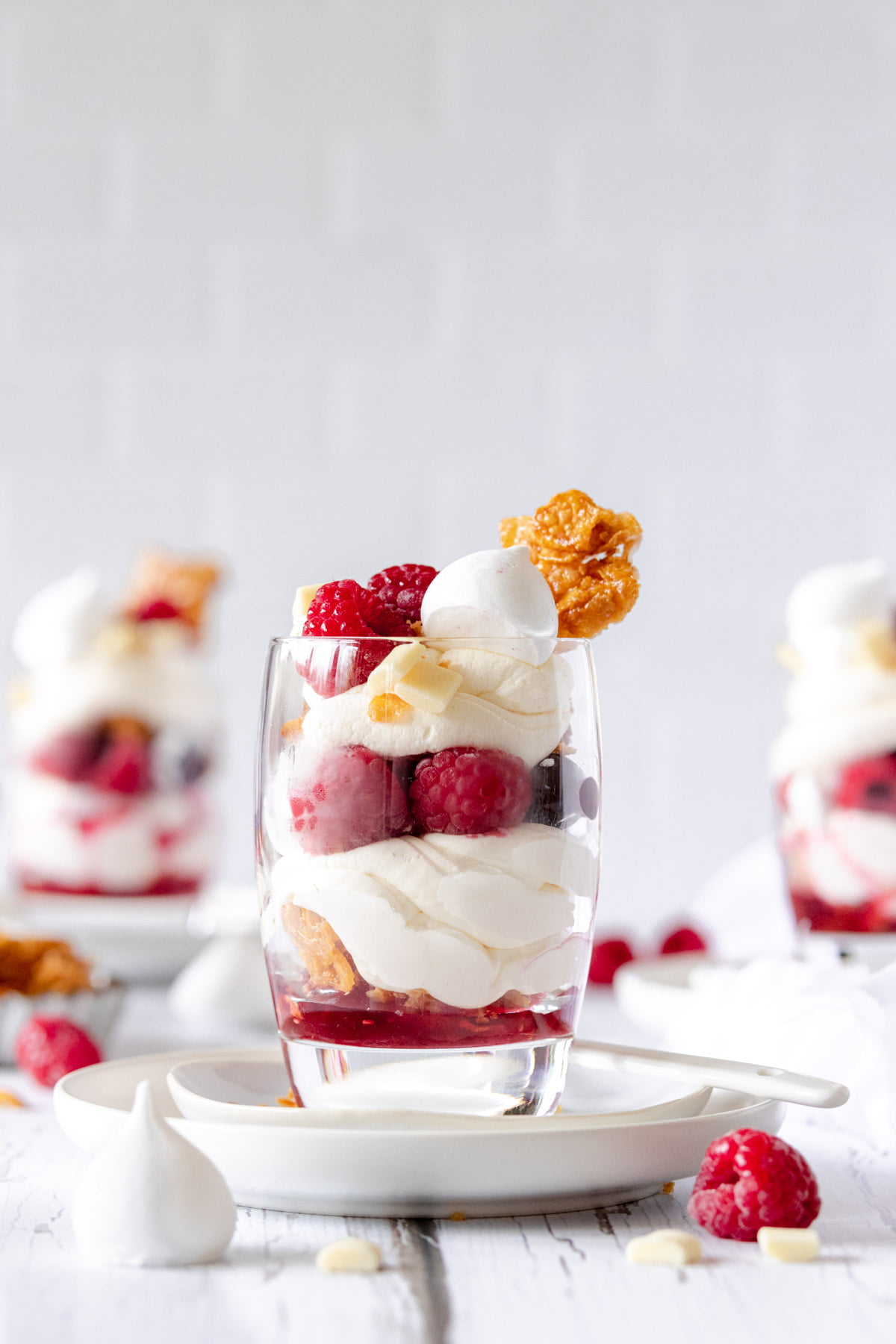 Raspberry Eton Mess in a glass topped with a honey Cornflake cluster