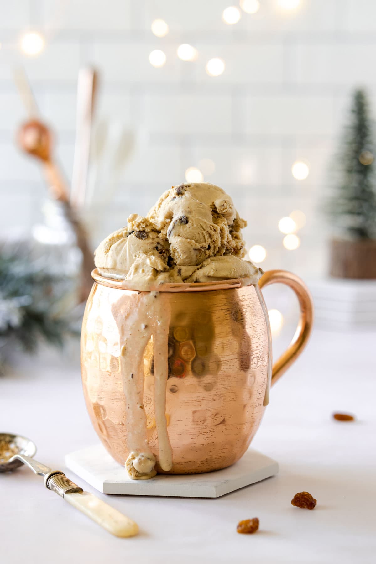 Christmas Pudding ice cream in a copper mug and fairy lights in the background
