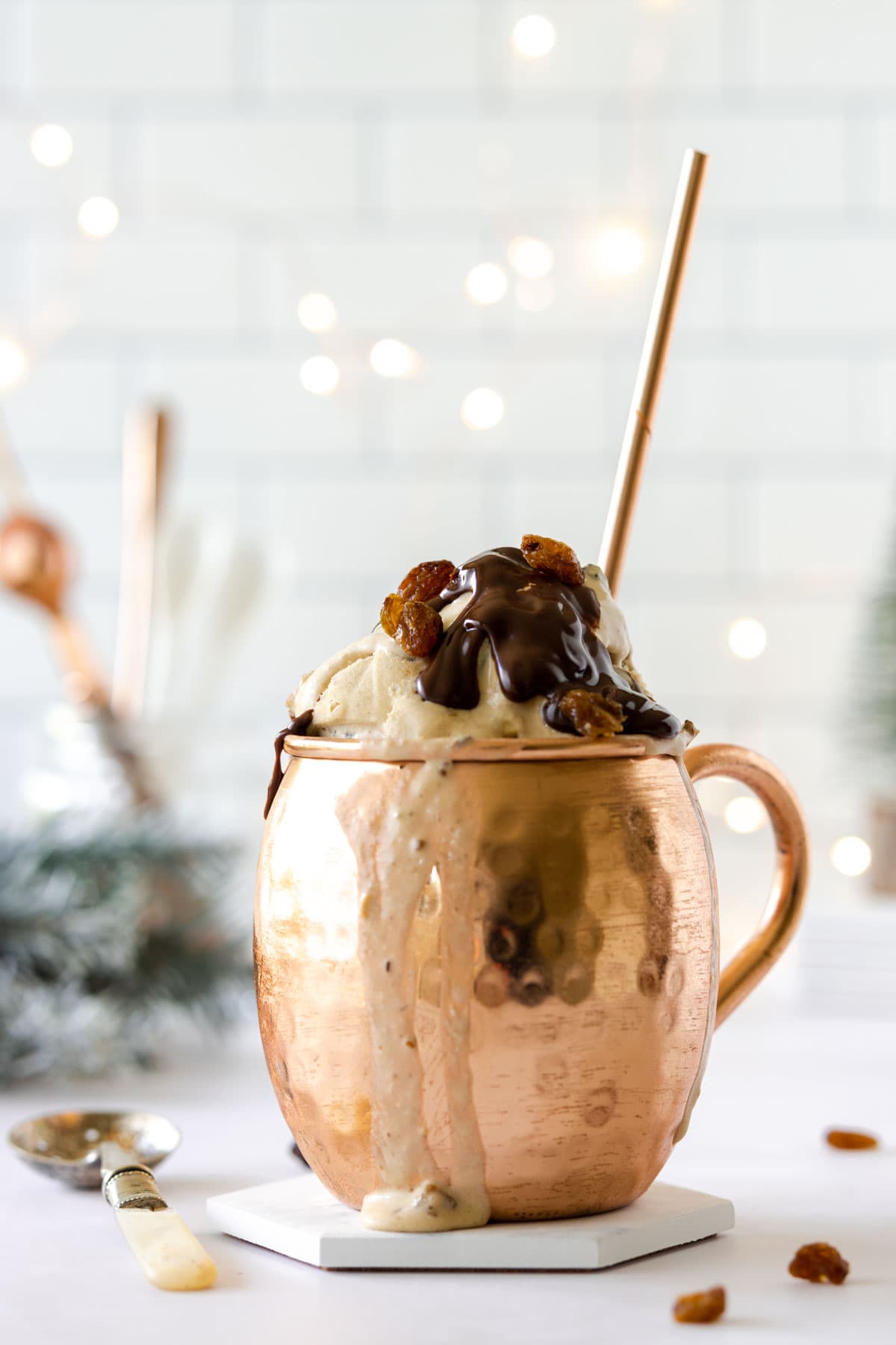 Ice cream with a chocolate topping in a copper mug, with ice cream melting down the side