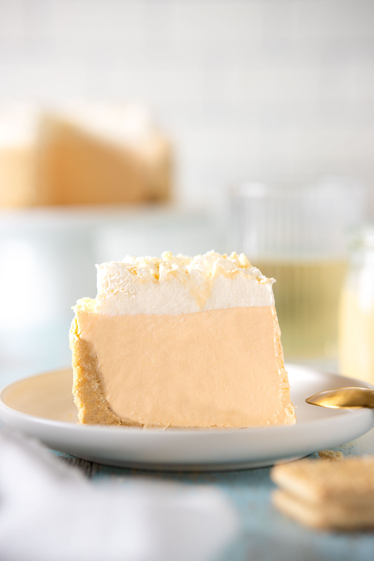 Slice of custard cream cheesecake on a white plate