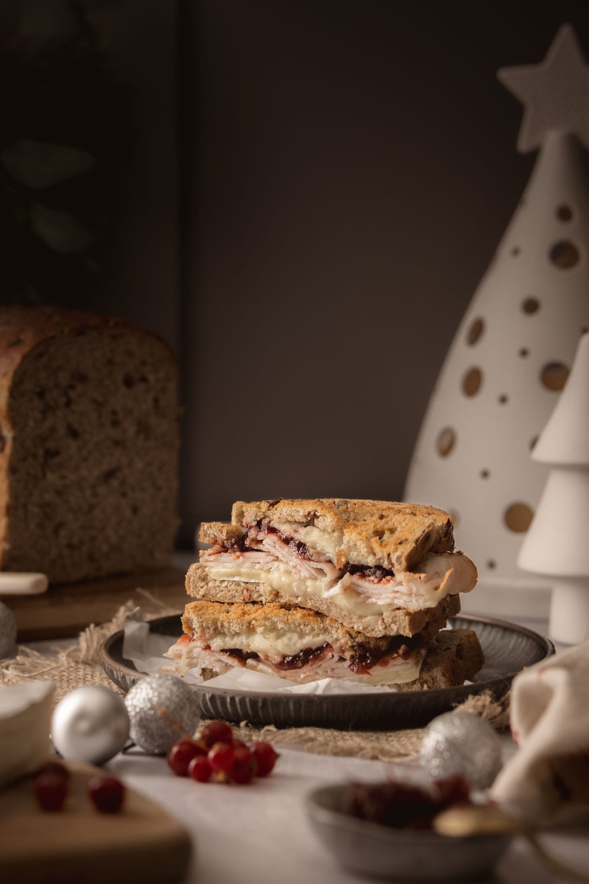 A vintage toned image of a Boxing Day Leftovers sandwich filled with turkey, cranberry and brie cheese - Photography and styling by Lou Carruthers, Food Photographer