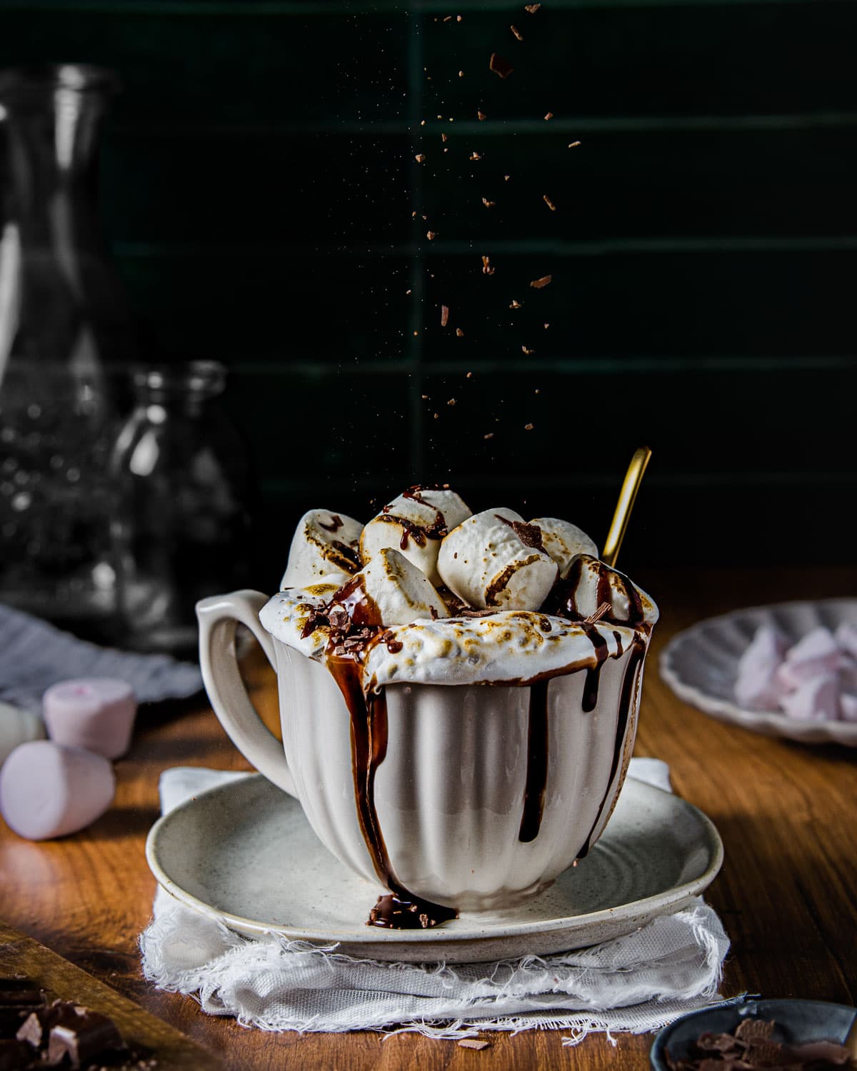 Chocolate sprinkles falling on a mug of marshmallow topped hot chocolate - Food Photography and Styling by Lou Carruthers, Crumbs and Corkscrews