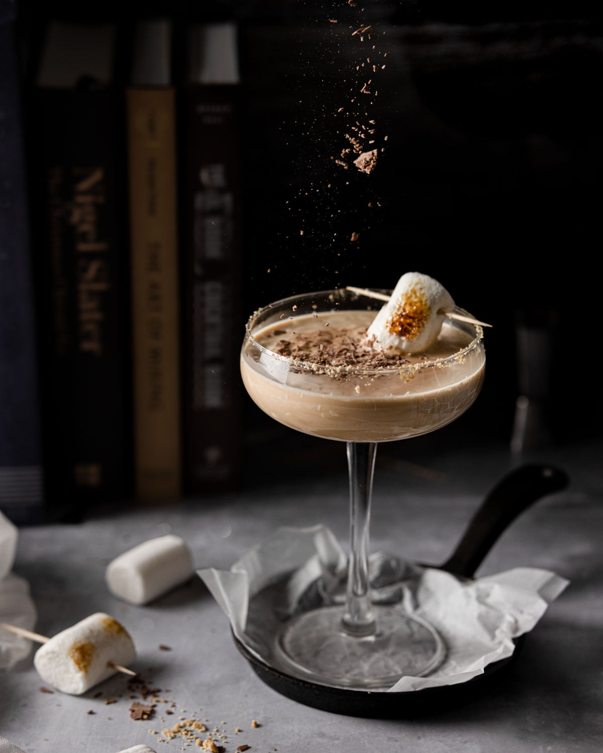 A chocolate smore's martini being sprinkled with biscuit crumbs - Food Photography and Styling by Lou Carruthers, Crumbs and Corkscrews